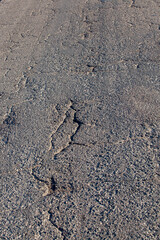 an asphalt road with holes
