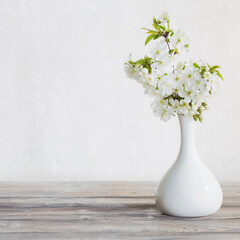 cherry flowers in vase on white background