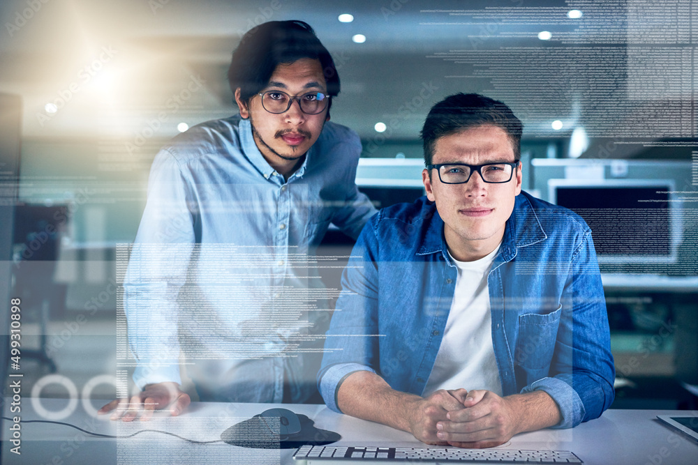 Leinwandbilder They are the specialists in this field of work. Portrait of two young male programmers working on a computer together in the office at night.