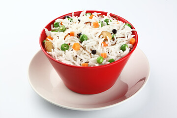 Red Bowl with rice and vegetable, green peas and carrots 