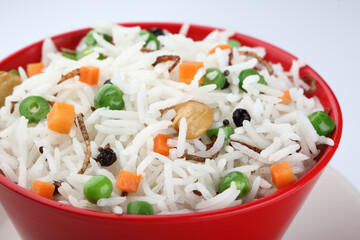 Red Bowl with rice and vegetable, green peas and carrots 