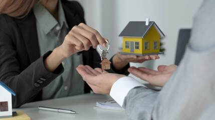 The house selling broker holds the keys and the model house is given to the customers,Real estate concept.