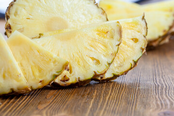 cut into pieces ripe yellow pineapple on the table