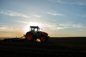 Fototapeta premium Tractor working in the field