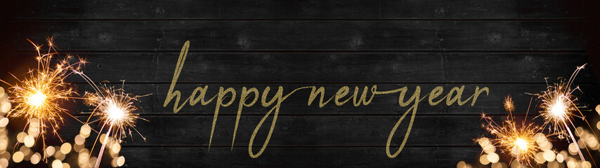 bokeh golden flares and sparkler isolated on rustic black wooden texture - Holiday New Year's Eve...