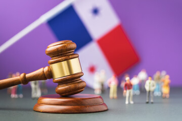 Judge gavel with blurred Panama flag and plastic toy men background, Panama society litigation...