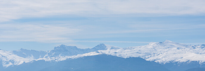 Panoramic view of Sierra Nevada (Granada, Spain) completely covered in snow, with its three peaks...