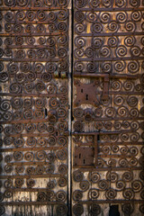 old wooden door with old and rusty iron lock