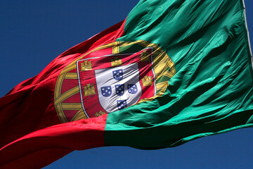 closeup flag of portugal in blue sky