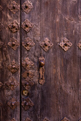 old wooden door with old and rusty iron lock