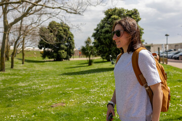 A tourist girl with a backpack in nature.