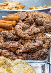 Grilled chicken meats and cookies on a street market close up shot