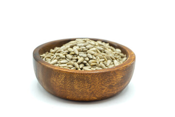 Sunflower seeds in wooden bowl isolated on white background