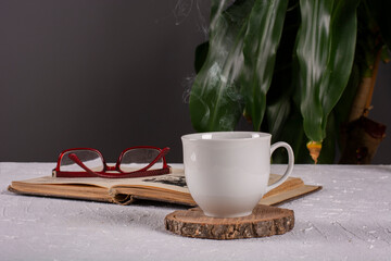 a cup of hot turkish tea and a book on the table