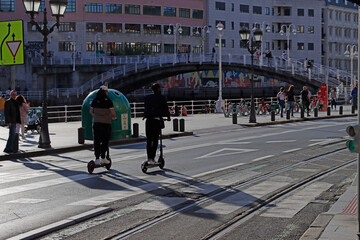 People moving with a e-scooter