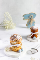 Easter cakes and wooden rabbit on a light background