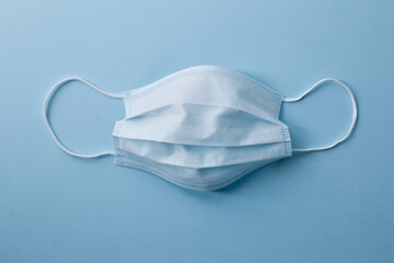 Respiratory masks on blue background. Protective medical mask. Coronavirus protection concept.