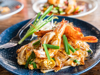 Pad Thai Gung Sod, Closed-up Thai Fried Rice Noodle with Prawns in the blue plate