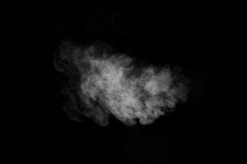 Swirling, wriggling smoke, steam, isolated on a black background for overlaying on your photos. Fragment of steam.
