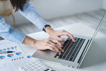 Close-up shot of a young woman typing on a keyboard.