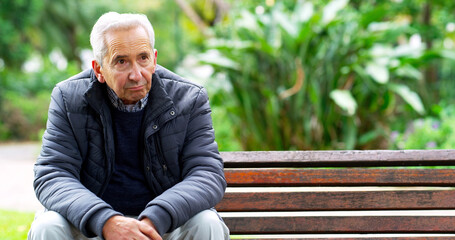 And now Im all alone. Cropped shot of a carefree elderly man seated on a bench while contemplating...