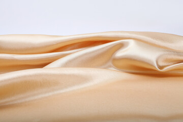 Gold beige pearl wave fabric silk. Abstract texture horizontal copy space background.