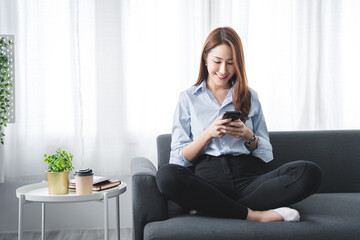 girl sitting on the sofa at home on the phone