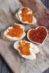 Fototapeta na wymiar natural red salmon caviar with baguette and butter