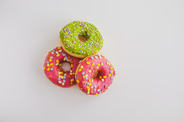 Pink and green donuts with powder. Delicacy.