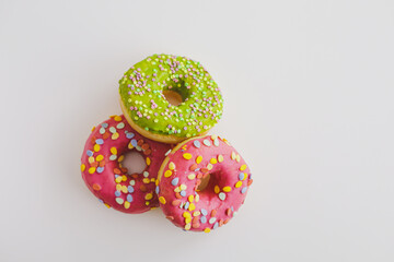Pink and green donuts with powder. Delicacy.