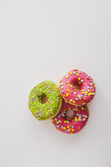Pink and green donuts with powder. Delicacy.