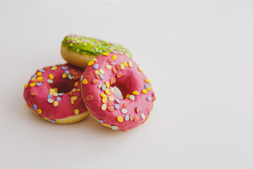 Pink and green donuts with powder. Delicacy.