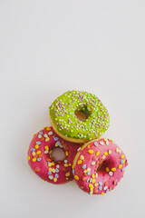 Pink and green donuts with powder. Delicacy.