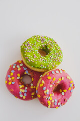 Pink and green donuts with powder. Delicacy.