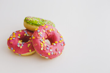 Pink and green donuts with powder. Delicacy.