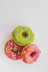 Pink and green donuts with powder. Delicacy.
