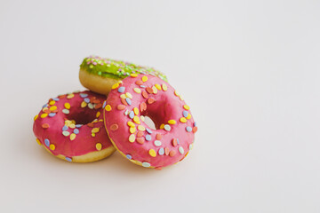 Pink and green donuts with powder. Delicacy.