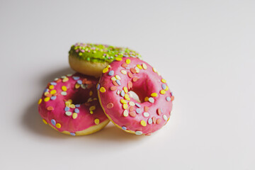 Pink and green donuts with powder. Delicacy.