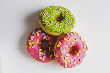 Pink and green donuts with powder. Delicacy.