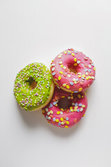 Pink and green donuts with powder. Delicacy.