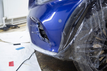 Installing a protective film on the car.Protection of the paintwork of the car.
