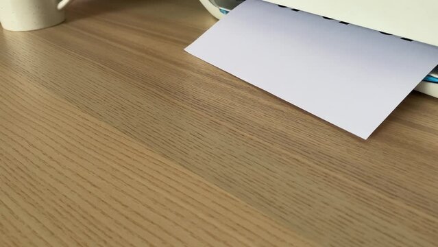 Printing &ldquo;SALE SALE SALE&rdquo; text written message on paper sheet document. Close up A4 page being printed from multifunction printer scanner on wooden desk in office. Worker hand take paper from printer