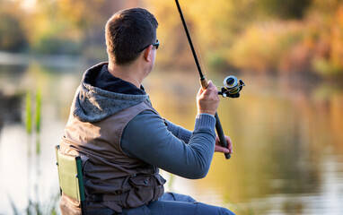 Fisherman angling on the river. Sport and recreation concept