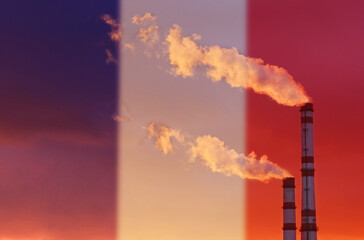 Against the background of the flag of France, smoke is emitted from the chimneys of the enterprise, polluting the air.