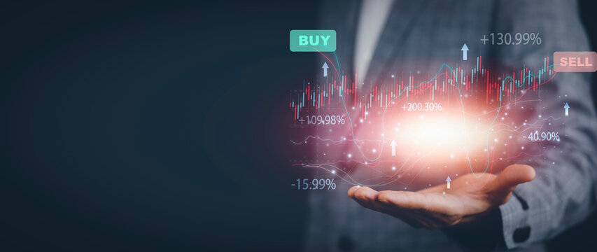 Businessman hold line of Stock market or forex trading graph and candlestick chart suitable for financial investment concept,Economy trends background for business idea and all art work design.