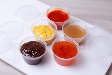 sauce for delivery in a saucepan on a white background