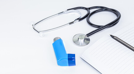 Stethoscope and asthmatic device on a white background