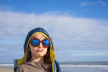 Little girl with sunglasses making a funny face