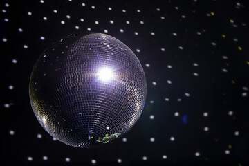 Fototapeta na wymiar Shiny silver disco ball hanging from the ceiling