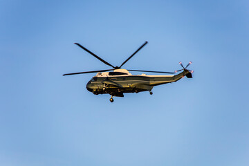 Green helicopter flying in the sky